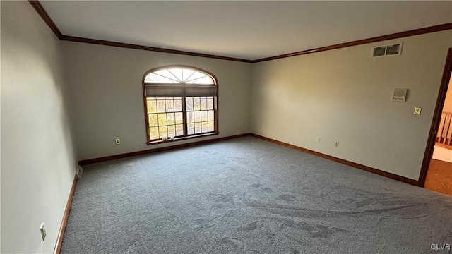 carpeted empty room with visible vents, baseboards, and ornamental molding