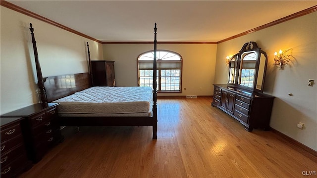 bedroom featuring crown molding, multiple windows, and wood finished floors