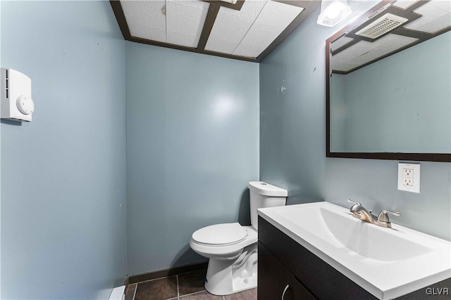 half bath featuring tile patterned flooring, toilet, vanity, and visible vents