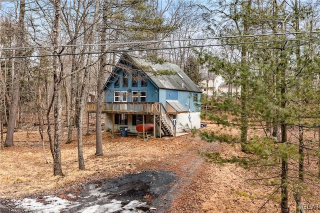 view of front of home with stairs and a wooden deck