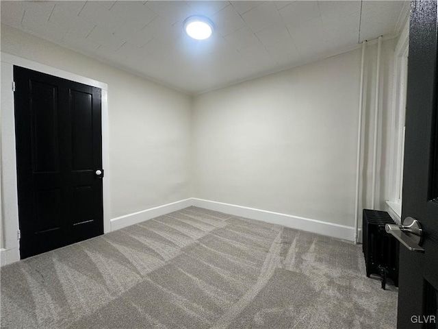 carpeted spare room with baseboards