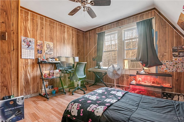 bedroom featuring cooling unit, wood finished floors, and wood walls