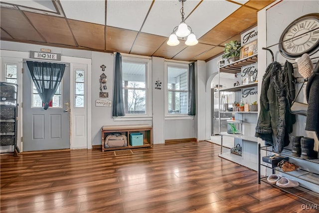 mudroom with arched walkways and wood finished floors