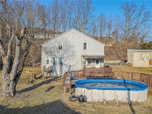 view of pool featuring a fenced in pool, a wooden deck, and a lawn