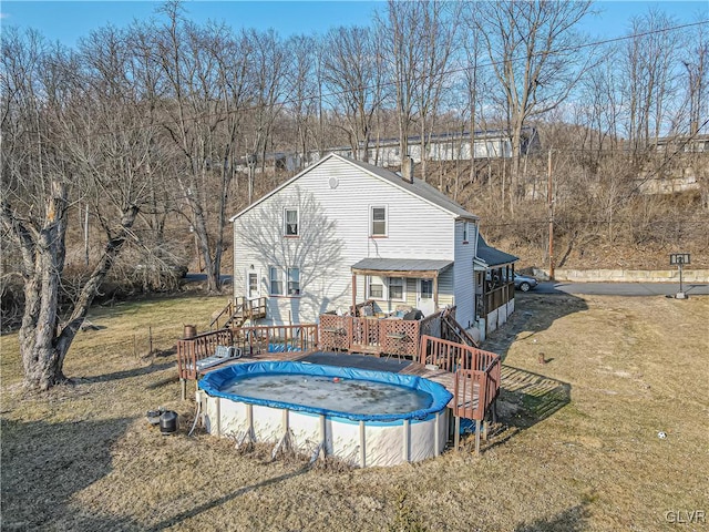 view of pool featuring a wooden deck, a yard, and a covered pool