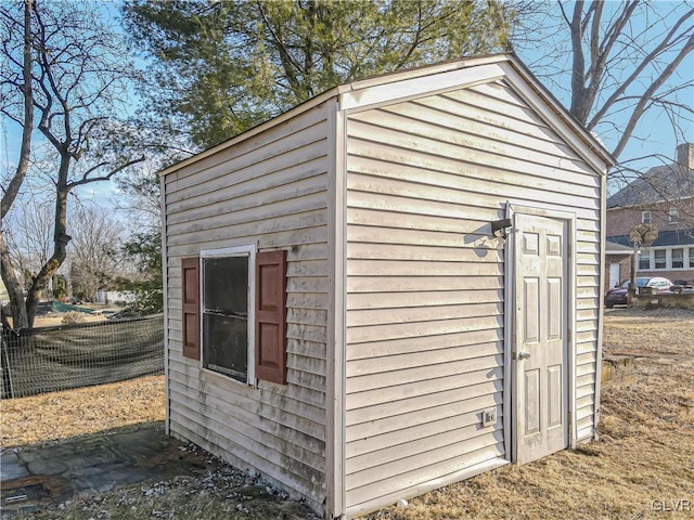 view of outbuilding featuring an outdoor structure and fence