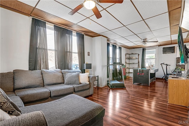 living room featuring a paneled ceiling, wood finished floors, and a ceiling fan