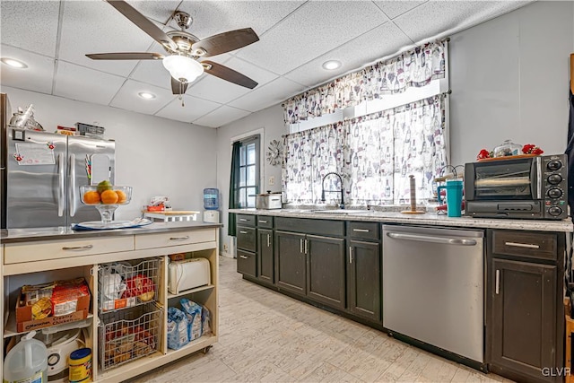 kitchen with a sink, a drop ceiling, recessed lighting, stainless steel appliances, and ceiling fan