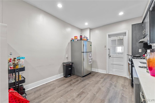 miscellaneous room featuring recessed lighting, light wood-type flooring, and baseboards