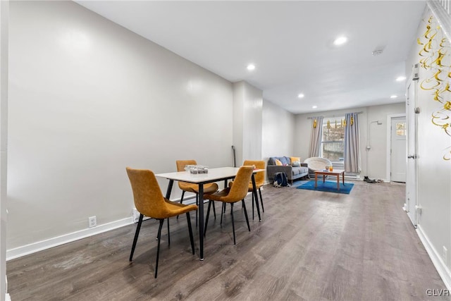 dining room with recessed lighting, baseboards, and wood finished floors