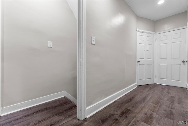 interior space with baseboards and dark wood finished floors