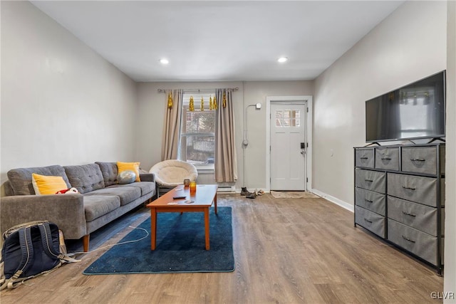 living room featuring recessed lighting, baseboards, and wood finished floors