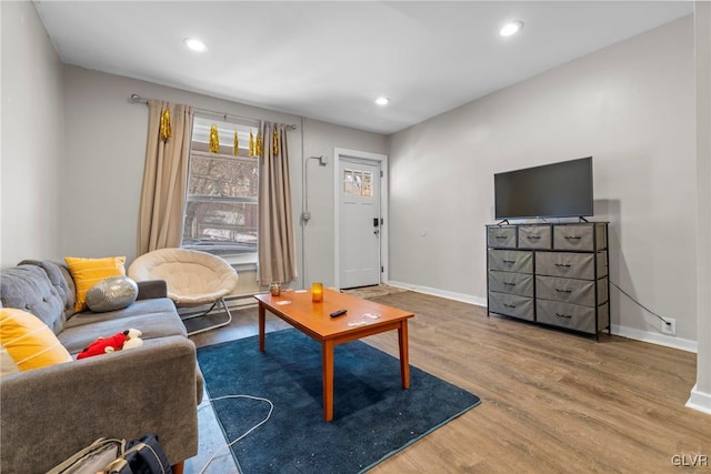 living area with recessed lighting, baseboards, and wood finished floors