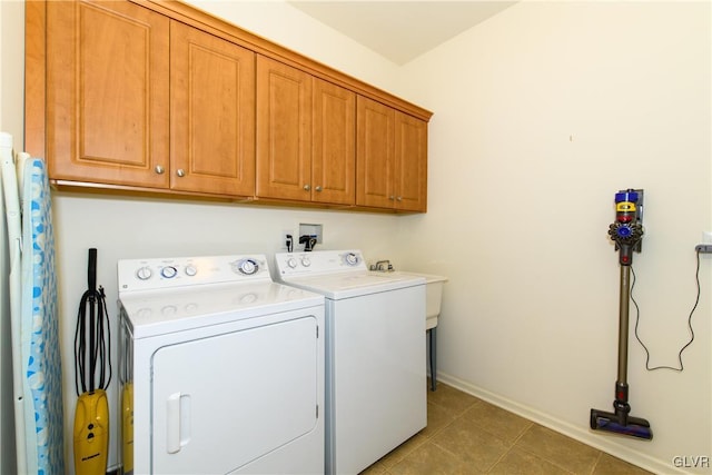 washroom with baseboards, cabinet space, independent washer and dryer, and tile patterned flooring