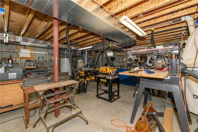 unfinished basement featuring a workshop area and water heater