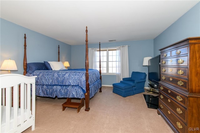 bedroom with light carpet, visible vents, and baseboards