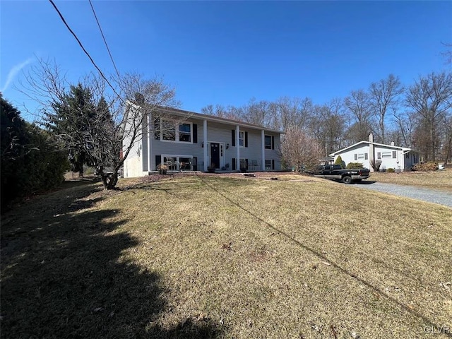 split foyer home with a front lawn