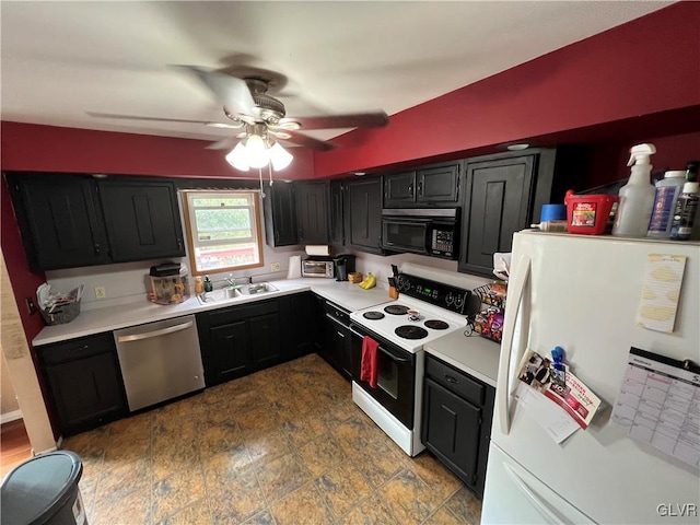 kitchen featuring black microwave, dishwasher, freestanding refrigerator, electric range, and dark cabinets