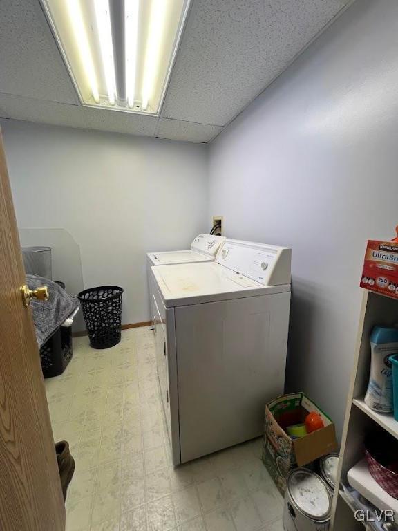 laundry area featuring light floors, independent washer and dryer, and laundry area