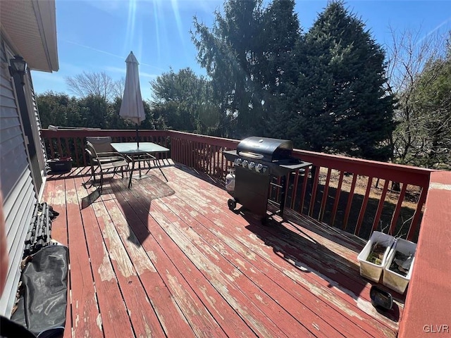 wooden terrace featuring area for grilling