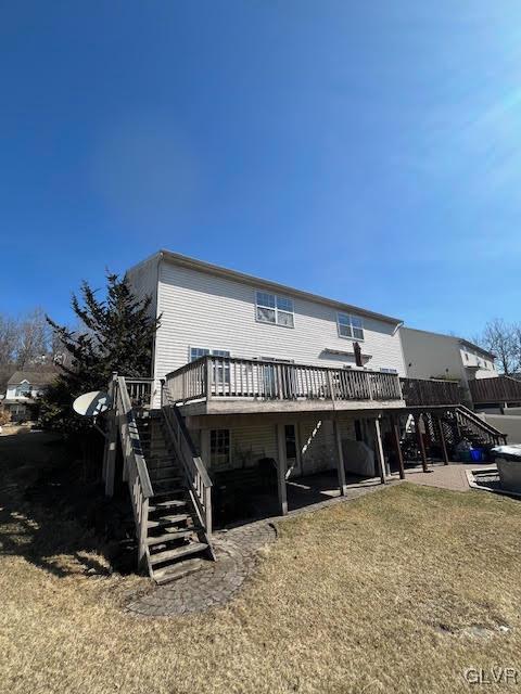 rear view of property with a yard, stairway, a patio, and a deck