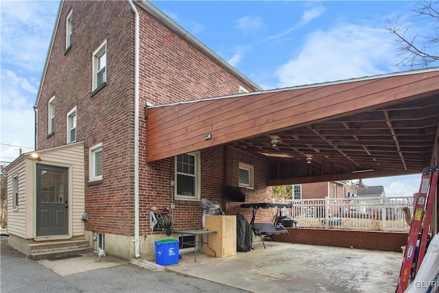 view of home's exterior featuring entry steps, a patio area, and brick siding