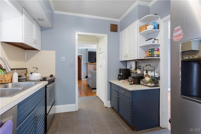 kitchen with blue cabinetry, appliances with stainless steel finishes, ornamental molding, and light countertops