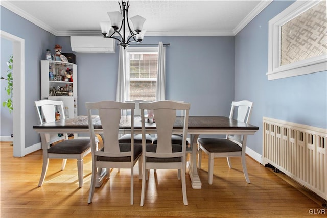 dining area featuring light wood-style flooring, radiator heating unit, ornamental molding, an AC wall unit, and a notable chandelier