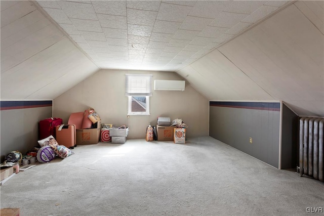 additional living space with vaulted ceiling, radiator, a wall unit AC, and carpet floors