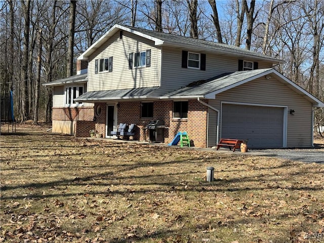 view of front of home with brick siding, driveway, and an attached garage