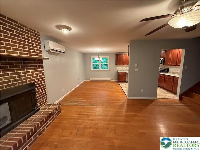 3965 Blacksmith Rd, Weisenberg Twp, PA 18066 - unfurnished living room featuring an AC wall unit, light wood-type flooring, a brick fireplace, a baseboard radiator, and ceiling fan