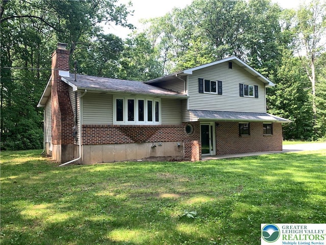 3965 Blacksmith Rd, Weisenberg Twp, PA 18066 - tri-level home with a chimney, brick siding, a front lawn, and view of scattered trees