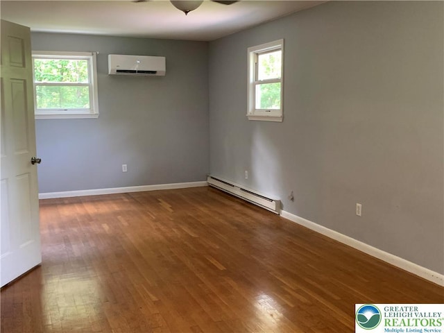 3965 Blacksmith Rd, Weisenberg Twp, PA 18066 - unfurnished room with a baseboard radiator, a wall mounted AC, healthy amount of natural light, and wood finished floors