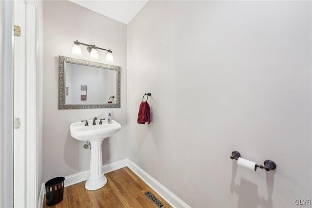 bathroom with visible vents, baseboards, and wood finished floors