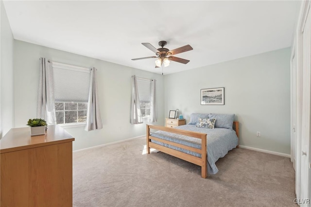 bedroom with a ceiling fan, carpet, and baseboards