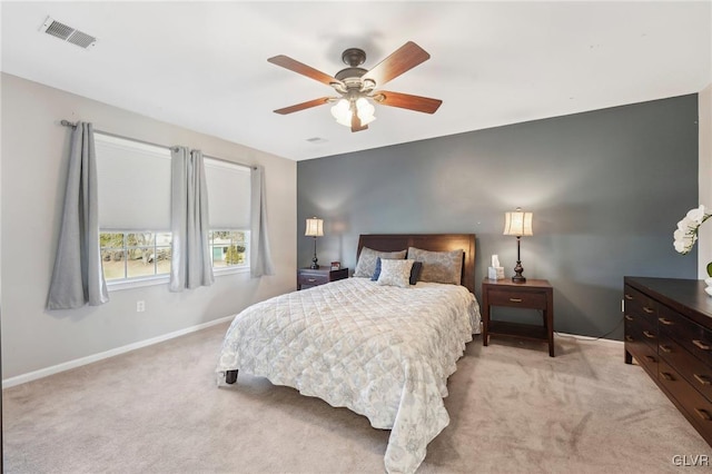 bedroom featuring visible vents, light carpet, baseboards, and a ceiling fan