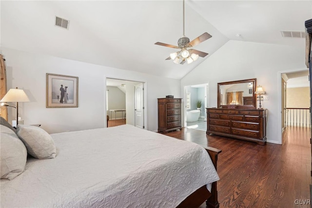 bedroom with visible vents, lofted ceiling, ensuite bath, and dark wood finished floors