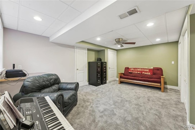 carpeted living area featuring visible vents, recessed lighting, a ceiling fan, and a drop ceiling