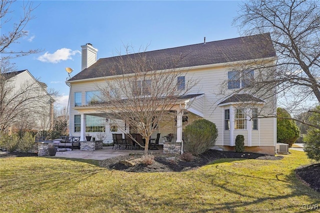 rear view of property featuring a patio, a yard, central AC unit, and a chimney