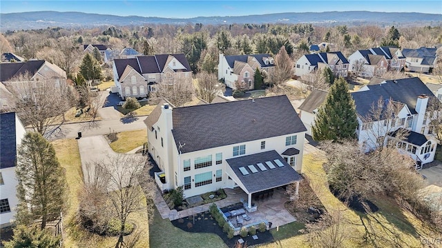 aerial view featuring a forest view and a residential view