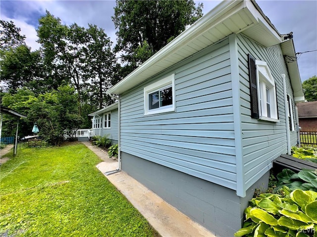 view of home's exterior featuring a yard and fence