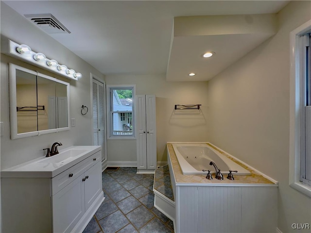 bathroom with vanity, visible vents, baseboards, recessed lighting, and a whirlpool tub