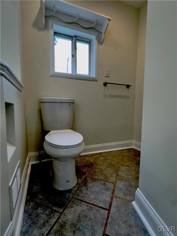 bathroom with visible vents, toilet, and baseboards