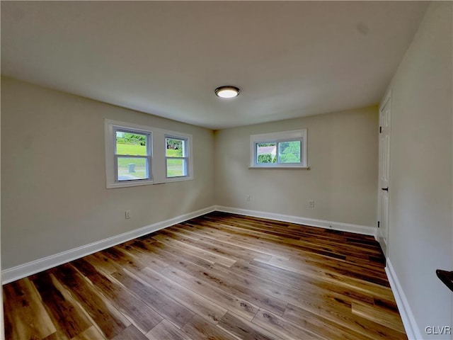 spare room with wood finished floors and baseboards