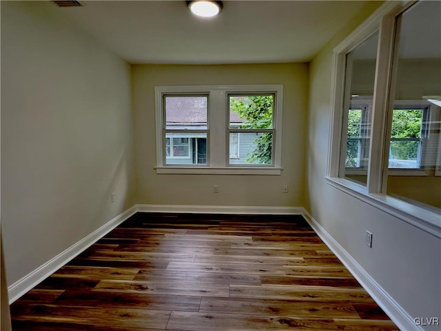 empty room with wood finished floors and baseboards