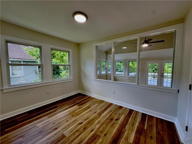 empty room with baseboards and wood finished floors