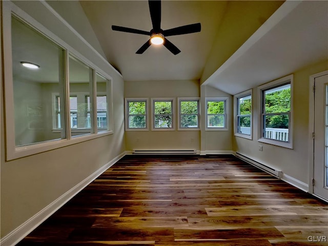 unfurnished sunroom with a baseboard heating unit, vaulted ceiling, and a wealth of natural light