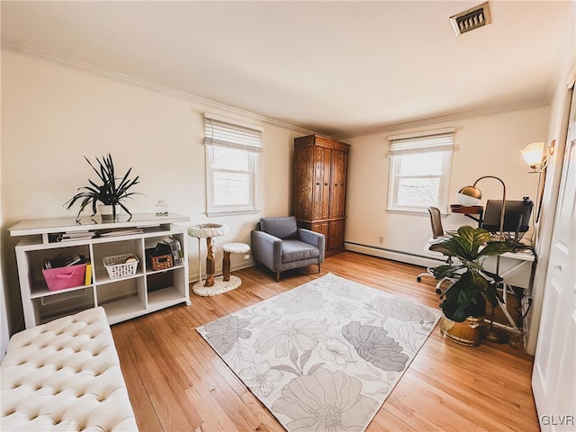 living area featuring visible vents, wood finished floors, a baseboard heating unit, and ornamental molding