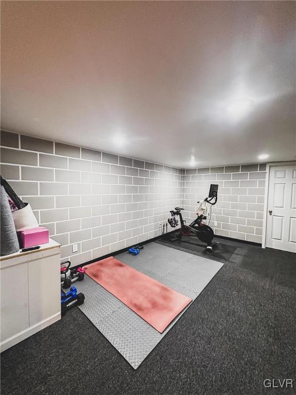 workout area with concrete block wall