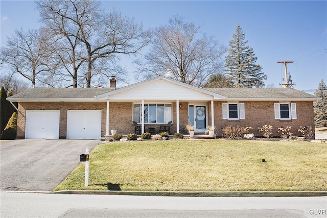 ranch-style house with brick siding, driveway, an attached garage, and a front lawn